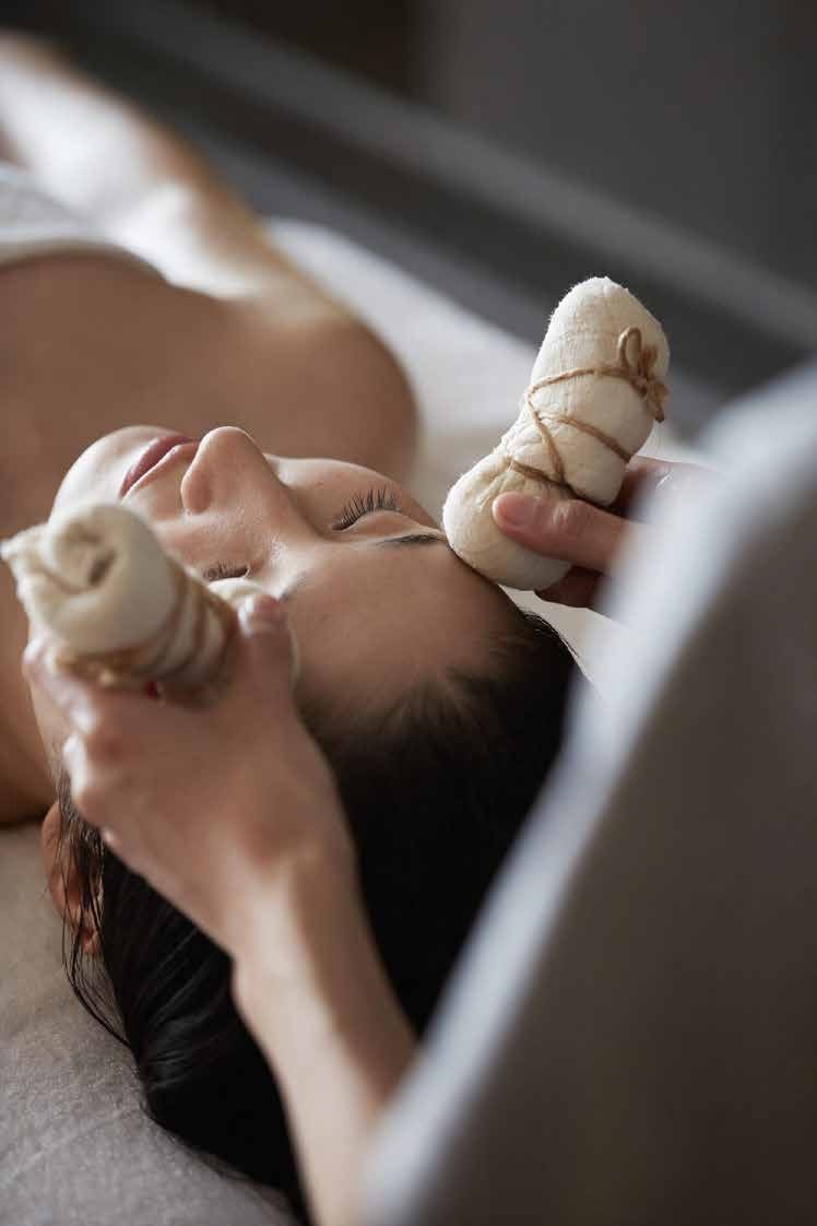 Therapist applying a warm herbal compress